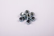 Stack of zinc plated self locking hexagon nuts on white background