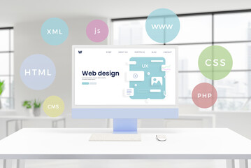 Fototapete - Computer display showcases a conceptual web design studio page with layout elements. Floating balloons feature HTML, PHP, CSS, XML, JS, CMS technologies