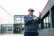 © Koldo_Studio - A senior businessman wearing virtual reality glasses and examining virtual elements in front of a modern office building.