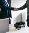 © Koldo_Studio - A close-up view of a handshake between a businessman and a client, symbolizing the successful deal for VR glasses in an office.
