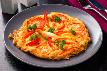 Canvas Print - Plate of food with tomatoes and peppers  a delicious and colorful dish