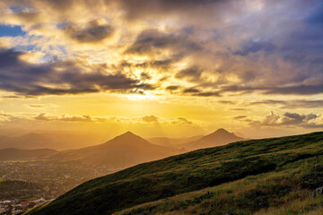 Wall Mural - Sunset in the mountains from a view with clouds and light