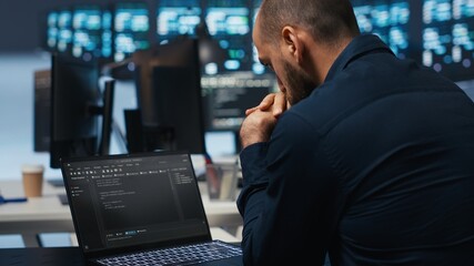 Poster - computer scientist overseeing data center servers, typing code on laptop, troubleshooting rigs. soft