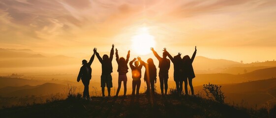 Silhouette of group happy business team making high hands over head in beautiful sunset sky evening time for business success and teamwork concept in company. International Friendship Day.