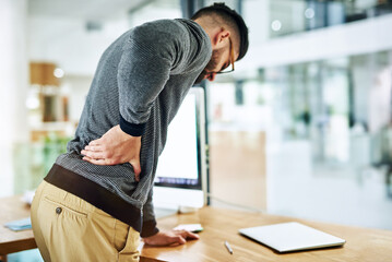 Poster - Back pain, business man and social media worker with strain, stress and anxiety by a computer in office. Tech, web and working with online, digital and internet project with work problem at company