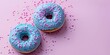 Sweet blue frosted donuts with sprinkles on pink