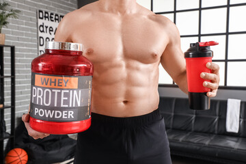 Sticker - Young muscular man with protein powder and shake at home, closeup