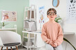 © Pixel-Shot - Little girl with trial frame in eye clinic