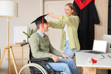 Wall Mural - Male graduate in wheelchair with his friend at home