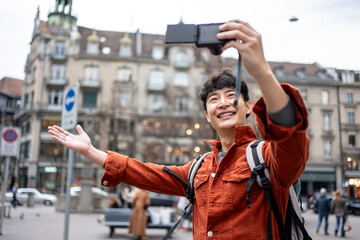 asian backpacker use camera taking a picture of beautiful landscape.