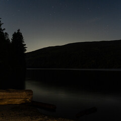 Wall Mural - night scene on mountain lake with calm water and cloudy sky