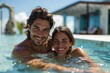 A man and woman are smiling and posing in a pool