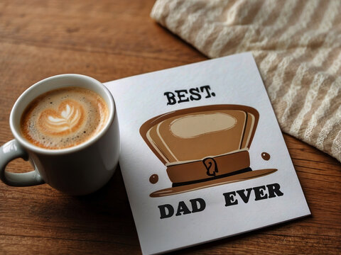Happy Father's Day close-up of the Best Dad Ever greeting card and coffee mug on the table design.