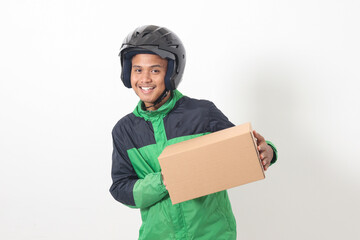Wall Mural - Portrait of Asian online courier driver wearing green jacket and helmet delivering package and box for customer. Isolated image on white background