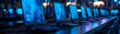 © Arrseman - A row of laptops with dark blue screens, illuminated by the glow from their monitors, sit on an interactive table