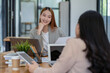 © Surachai - Two Asian businesswomen working Creative discussion in office using laptop and tablet, business concept