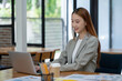 © Surachai - Asian business woman working In office using laptop and tablet, business concept