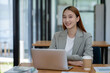 © Surachai - Asian business woman working In office using laptop and tablet, business concept