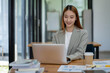 © Surachai - Asian business woman working In office using laptop and tablet, business concept