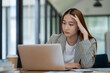 © Surachai - Asian businesswoman is tired and stressed in the office. Business concept.