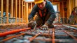 © G.Go - A plumber installing a radiant floor heating system in a new construction.