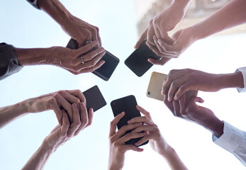 Poster - Group, low angle and hands with smartphone in networking, social media and online, digital and application. Team, people and below, tech and connection for communication, information and business