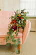 Vibrant Bridal Bouquet Cascades Down Pink Velvet Couch