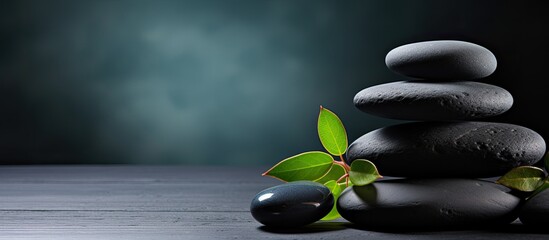 Poster - A serene spa composition with a stack of spa stones on a copy space image against a black background