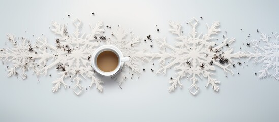 Wall Mural - The top view of a white background showcases a snowflake frame created using dried tea leaves offering ample copy space for personalized messages