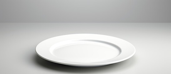 Poster - A plate with no food on it placed alone on a blank white background leaving space for the image. Creative banner. Copyspace image