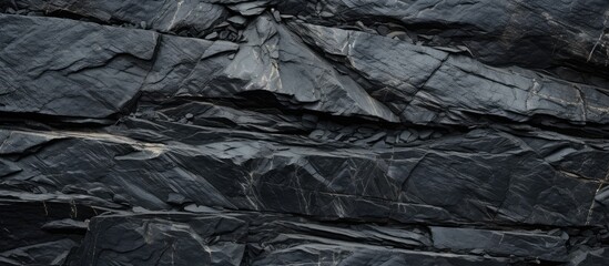 Fototapete - An abstract background or texture featuring a black stone on a slate like surface Perfect for copy space images