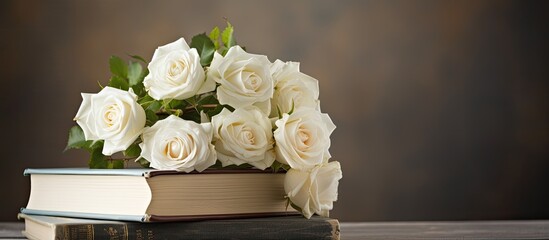 Sticker - A stack of books with beautiful white roses on top creating a lovely composition for a copy space image