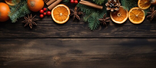 Poster - A rustic wooden background showcases a festive arrangement of Christmas tree branches adorned with paper dried oranges and anise creating a captivating copy space image
