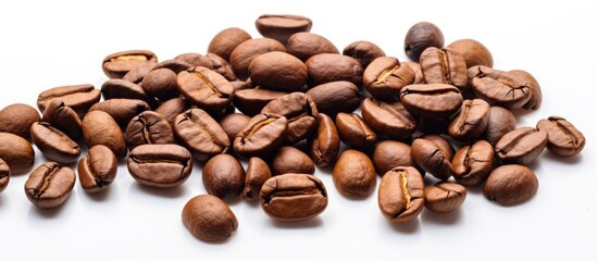Wall Mural - A high quality macro image of roasted brown and black coffee beans is isolated on a white background providing ample copy space for text