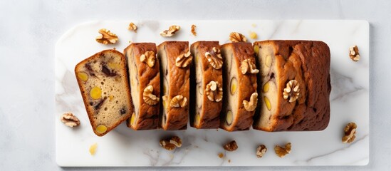 Poster - A sliced banana bread with walnuts arranged on a marble surface Top view providing room for design or text elements. Creative banner. Copyspace image