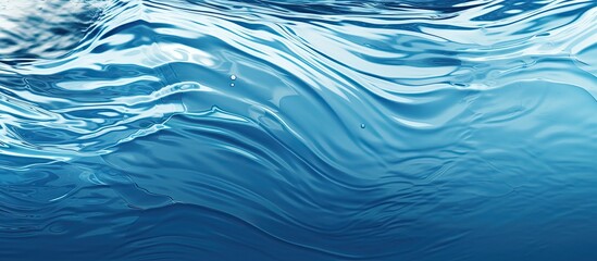 Poster - A copy space image with a background of blue liquid texture resembling fresh water featuring a ripple wave texture