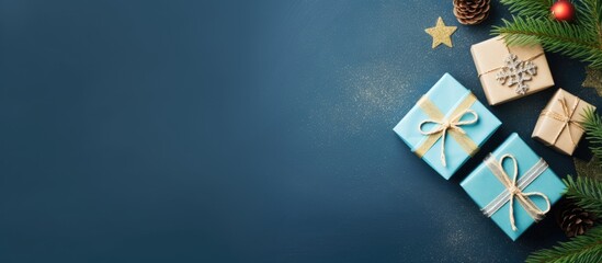 Leinwandbilder - Top view flat lay of Christmas gift boxes and a fir tree on a blue background providing copy space for your greetings