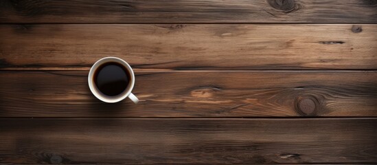 Aufkleber - A top down perspective showing an old wooden surface with a cup of black coffee perfect for a copy space image 108 characters