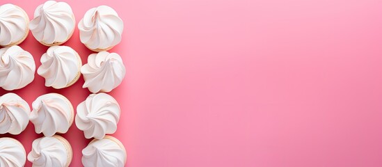 Aufkleber - A flat lay style image featuring homemade mini meringues in vibrant colors set against a pink background with plenty of copy space