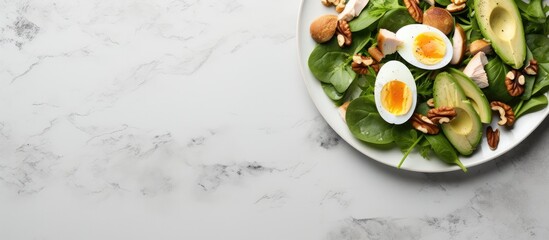 Poster - Copy space image of a keto friendly meal consisting of avocado slices grilled chicken quail eggs spinach and walnuts This high fat clean eating recipe is ideal for weight loss The close up top view c