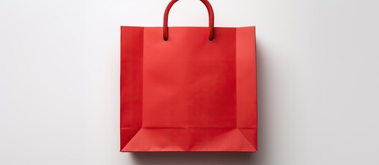 Sticker - Top view of a red paper bag on a white background with copy space The image is a flat lay mock up