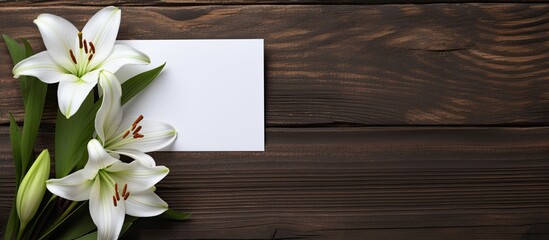 Poster - A copy space image of a white greeting card and craft envelope adorned with lilies flowers placed on a dark wooden background