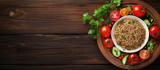 Poster - Top view of a plate with fresh vegetables and buckwheat placed on a wooden background offering a copy space image