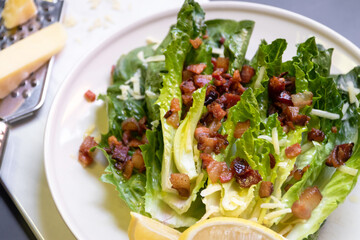 Wall Mural - Cos lettuce salad with crispy bacon, and parmesan cheese. Easy healthy recipes.