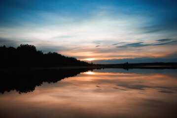 beautiful landscape. the sun sets over the lake