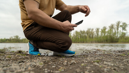 Canvas Print - Person using mobile phone outdoors 