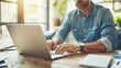 © Ilja - Focused businessman working intensely on laptop in office closeup for productivity