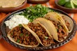 Savory ground beef tacos with cilantro, onions, and a side of creamy sauce