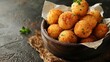 Deep fried arancini balls on rustic background - traditional Italian cuisine. Stuffed rice balls.