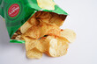 © manassanant - Bangkok, Thailand - May 15, 2022 Potato chips in open bag, delicious BBQ seasoning spicy for crips, thin slice deep fried snack fast food in open bag.